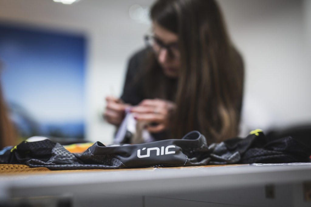 Woman working on a custom uniform.